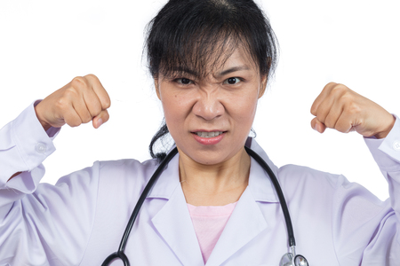 Angry Asian female doctor showing threatening fists in isolated White Backgroundの写真素材