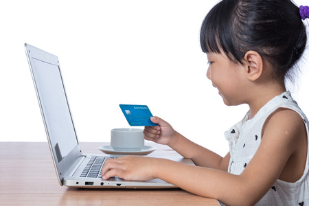 Asian Chinese little girl making online payment in isolated white background