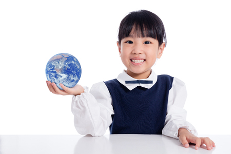 Asian Little Chinese Girl Holding a World Globe in isolated White Backgroundの写真素材