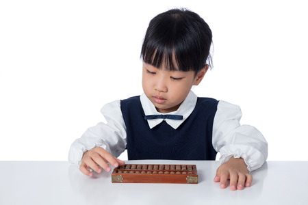 Asian Chinese little girl playing abacus in isolated white backgroundの写真素材