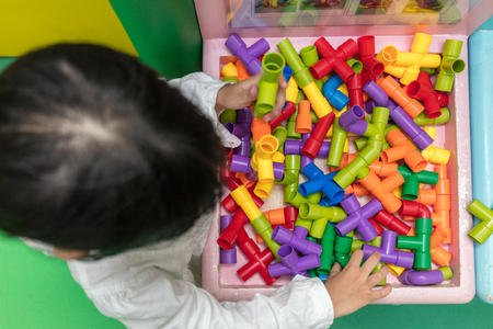 Asian Little Chinese Girl playing puzzle tube at Indoor Playgroundの写真素材