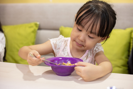 Asian Little Chinese Girl having lunch at restaurantの写真素材