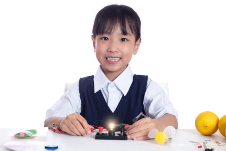 Asian chinese little girl doing experiments in isolated white background