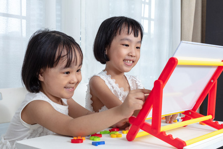 Asian Chinese little girls playing toys at homeの写真素材