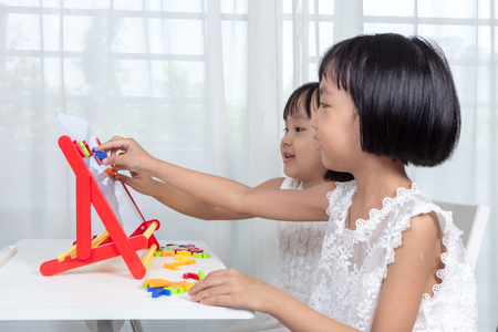 Asian Chinese little girls playing toys at homeの写真素材