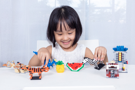 Asian Chinese little girl playing puzzle toys at homeの写真素材