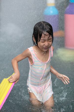 Asian Little Chinese Girl playing at water park outdoorの写真素材