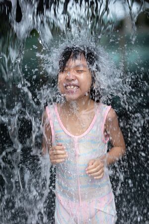 Asian Little Chinese Girl playing at water park outdoorの写真素材