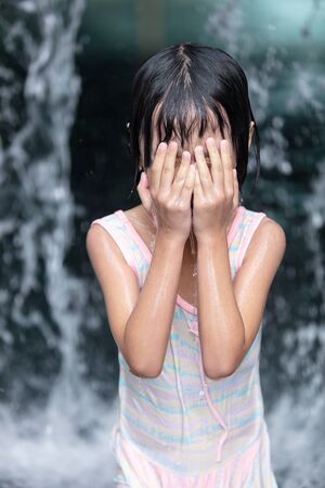 Asian Little Chinese Girl playing at water park outdoorの写真素材