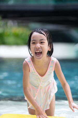 Asian Little Chinese Girl playing at water park outdoorの写真素材