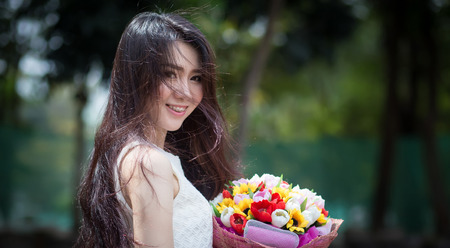 Asia cute woman with  flower  bouquetの写真素材