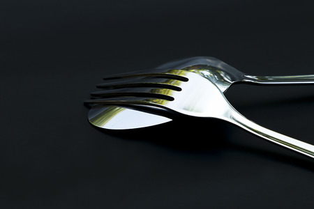 Spoon with dish set on black background for decoration.の写真素材