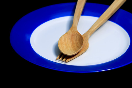 Spoon with dish set on black background for decoration.の写真素材