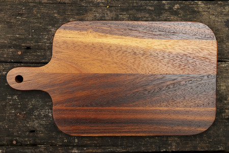 Cutting board wood decorated on wooden backgrou nd.