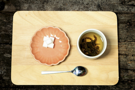 Hot  tea decorated with cookies on wooden background.