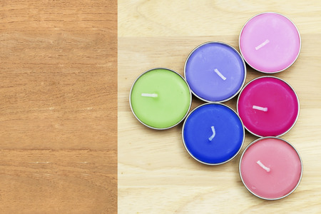 Color candles on wooden background.の写真素材