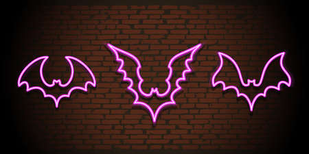 Neon bats silhouettes on brick wall backgroundの写真素材