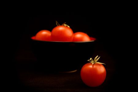 dish of tomatoes on the black backgroundの写真素材