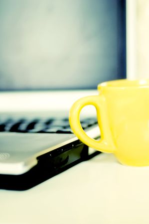 cup of coffee and laptop. cross-processedの写真素材