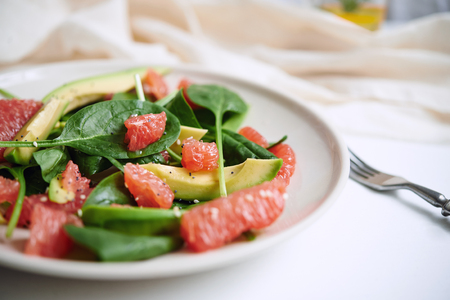 healthy salad with avocado, grapefruit and spinach. selective focusの写真素材
