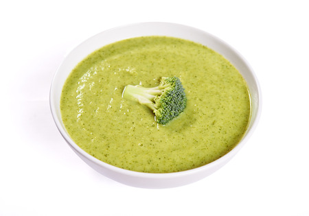 bowl of fresh green broccoli soup isolated on white backgroundの写真素材