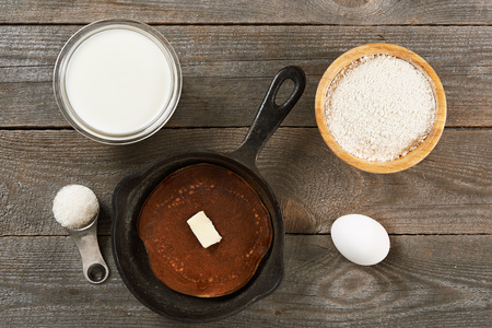 ingredients for baking pancakes over wooden background/ top viewの写真素材