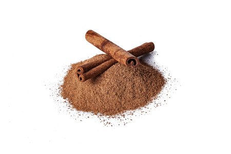 sticks of cinnamon and cinnamon powder isolated on white backgroundの写真素材
