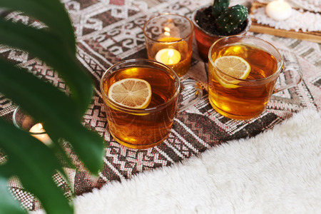 tea with lemon and mint and candles. cozy still lifeの写真素材