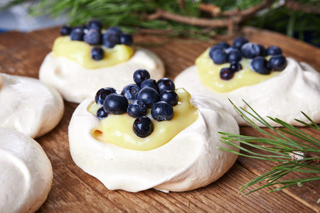 meringue nests topped with lemon curd and blueberryの写真素材