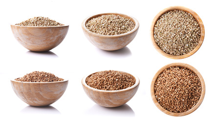 bowls with green and brown buckwheat isolated on white backgroundの写真素材