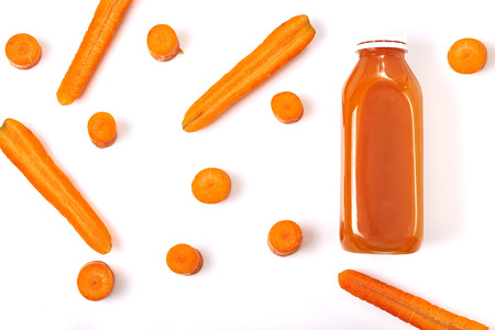 carrot juice and carrots  over white background. top viewの写真素材