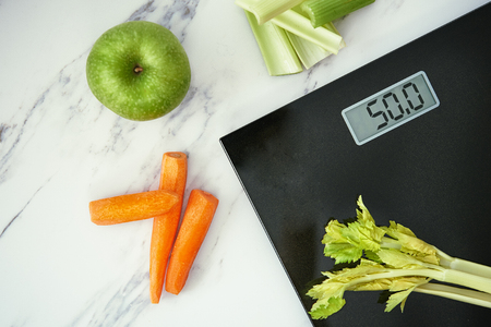 weight scale, apple, carrrot and celery. top viewの写真素材