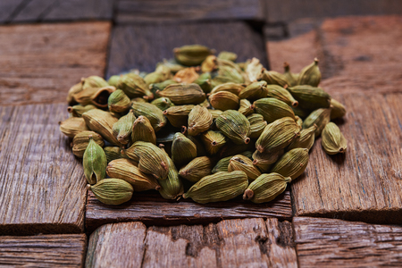 green cardamom pods on rustic wooden background.の写真素材
