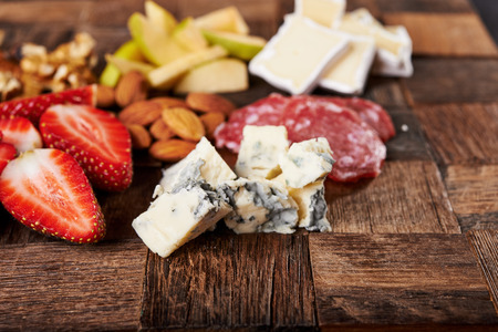 cheese board with fruits and nutsの写真素材