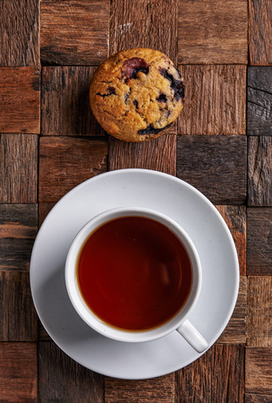 cup of black tea and blueberry muffin. top viewの写真素材