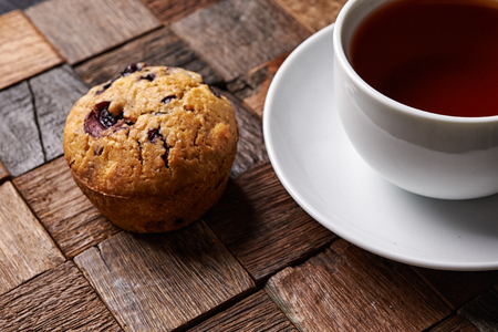 cup of black tea and blueberry muffin.の写真素材