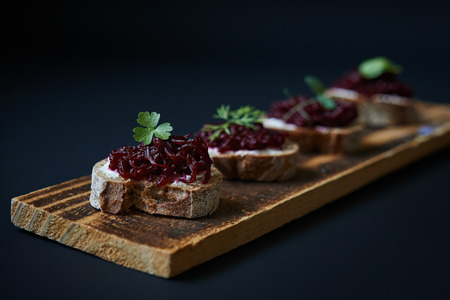 open sanswiches with beetroot on wooden boardの写真素材