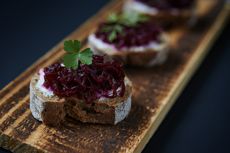 open sanswiches with beetroot on wooden boardの写真素材