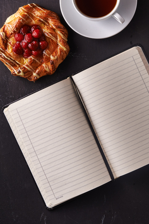 notebook with empty sheets, baking and tea. top viewの写真素材