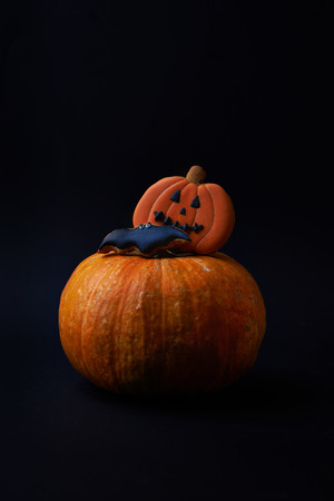 ripe orange pumpkins and cookies on dark backgroundの写真素材