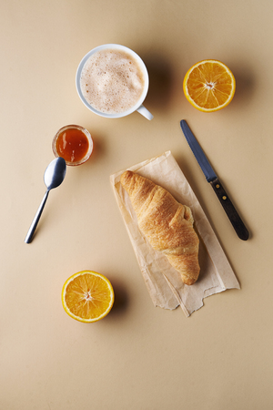 croissant, jam, coffee and orange. top view, conceptual still lifeの写真素材