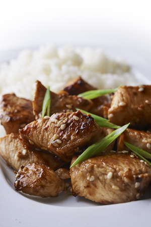 plate of teriyaki chicken and rice isolated on white backgroundの写真素材