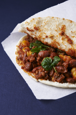 flatbread with meanced meat, corn and beans.  blue backgroundの写真素材