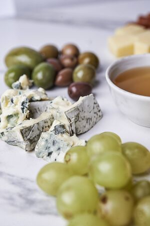 cheese board with different type of cheese, nuts and fruitsの写真素材