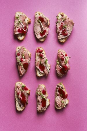 open sandwiches with roast beef and lingonberry sauce. top view