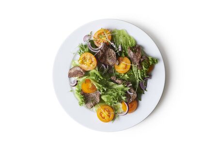 salad with roast beef, toamato and onion isolated on white backgroundの写真素材