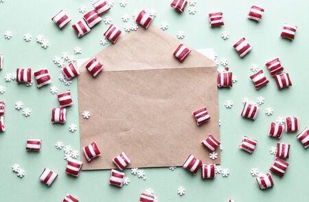 christmas candies and sweet snowflakes on mint color background and place for text