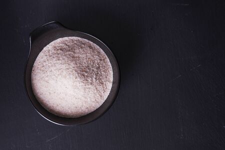 bowl with himalayan salt on black background