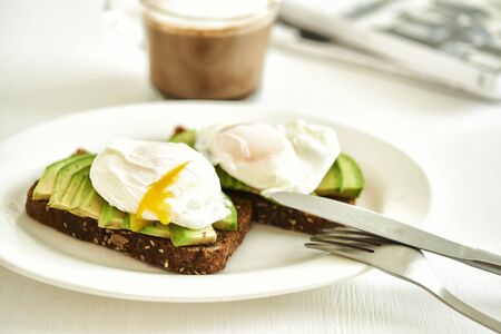 ray bread toast with avocado and egg poached