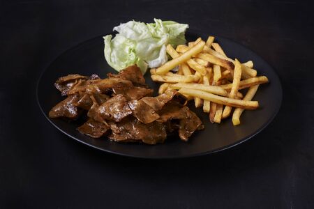 plate of meat free doner cebab with french fries and saladの写真素材